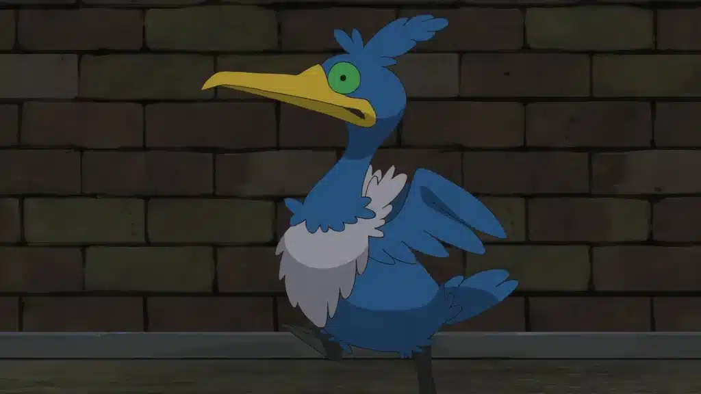 Cramorant standing upright with a long beak and wide eyes, set against a dark brick wall background