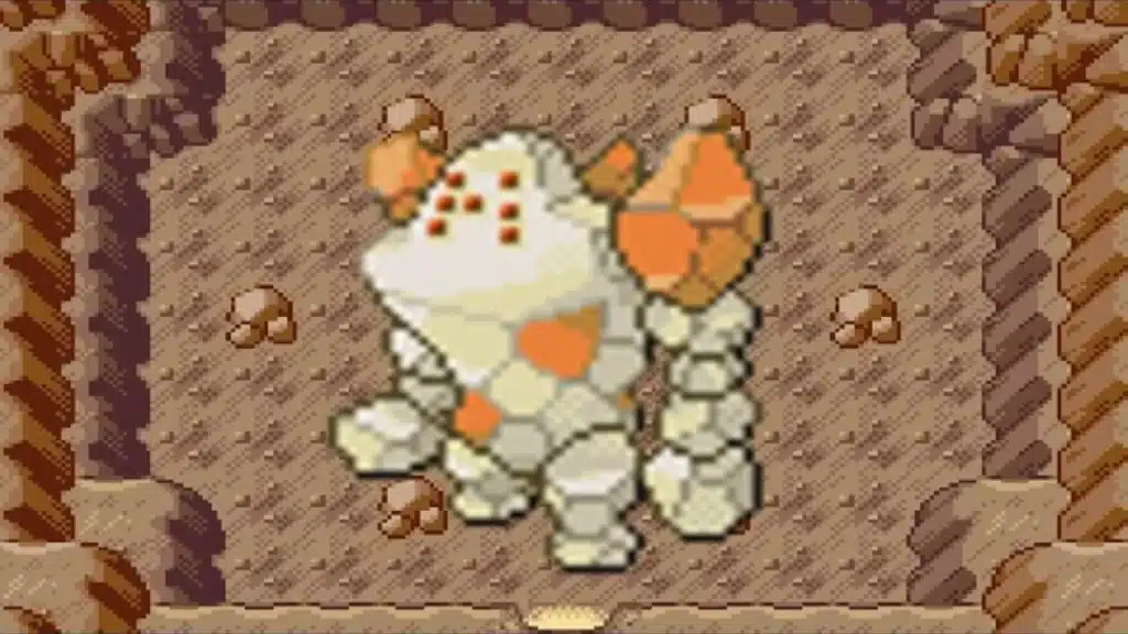 Pixel art Regirock in a rocky cave, stone body with orange patches and dot pattern on its face
