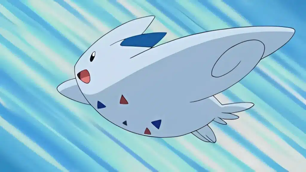 Togekiss gliding smoothly through the sky with small wings and a cheerful expression against a streaked background