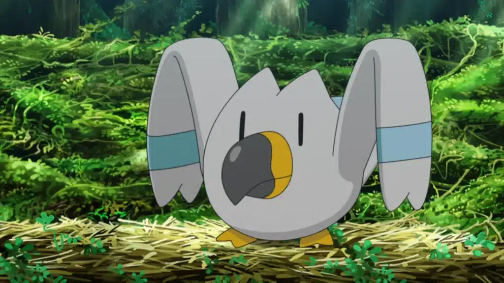 Wingull standing on the ground with wings raised, showing its white body and long beak in a forest setting