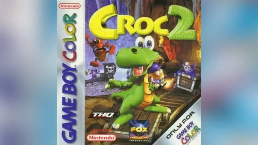 Croc 2 Game Boy Color cover showing Croc smiling in a cave with small creatures and pirate flags behind him