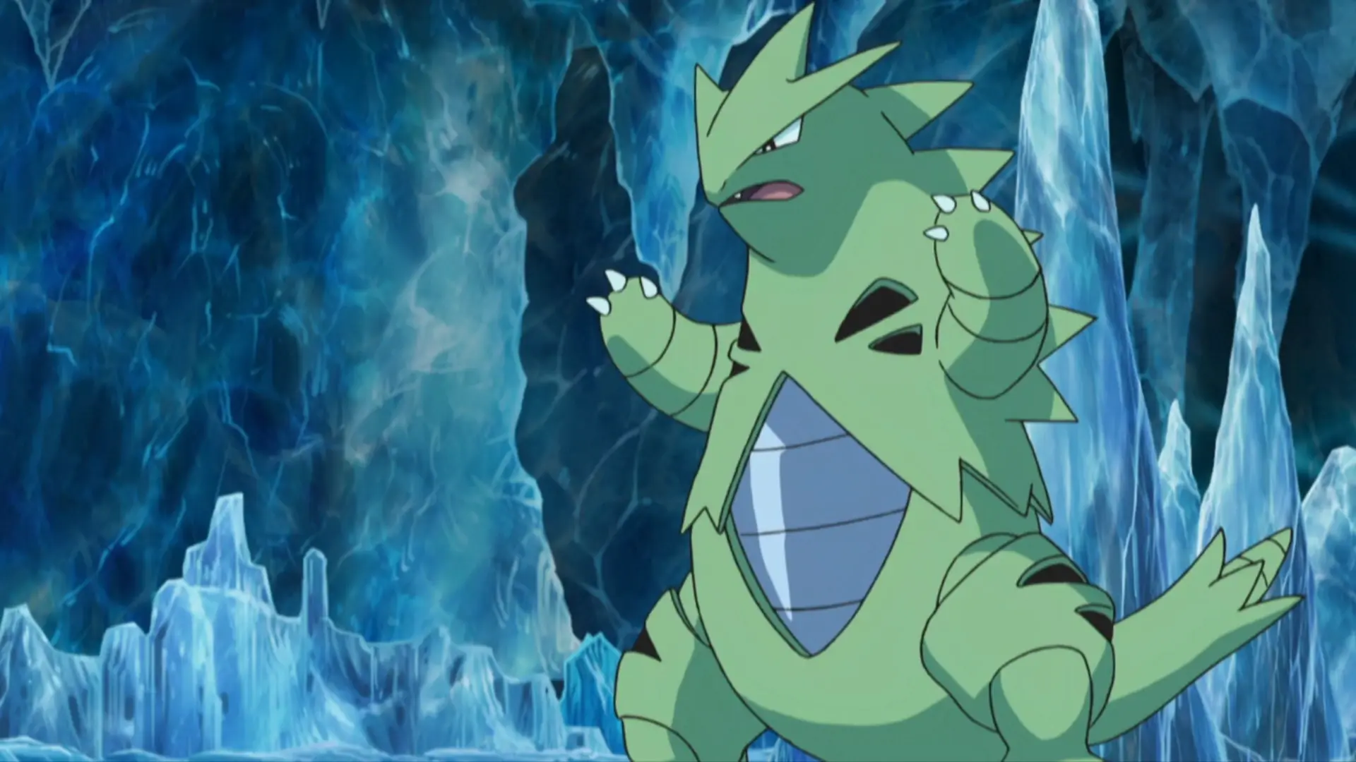 Tyranitar standing in an icy cave with blue crystals, ready to battle with arms raised and fierce expression