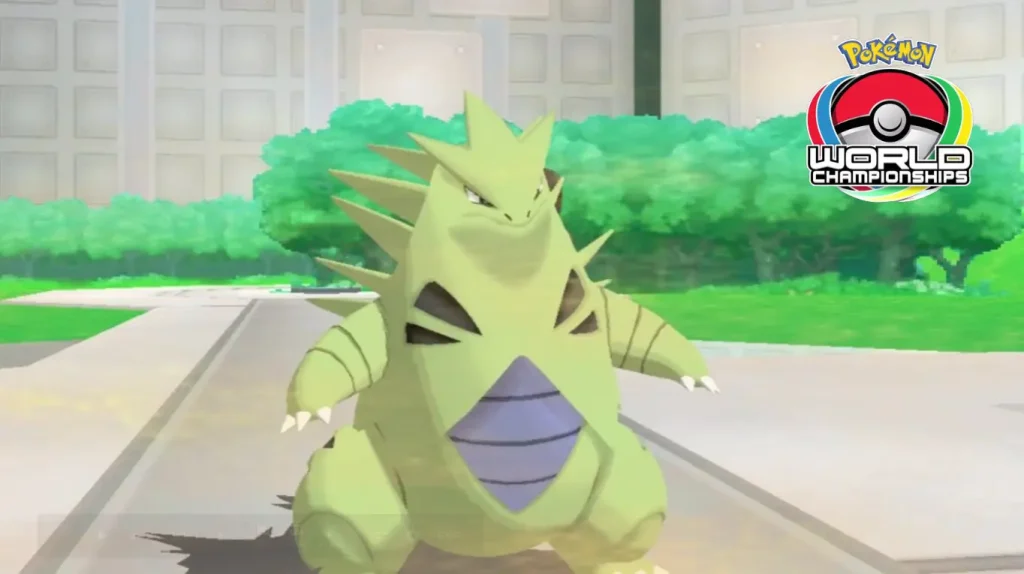 Tyranitar standing in battle arena with greenery and Pokémon World Championships logo in background